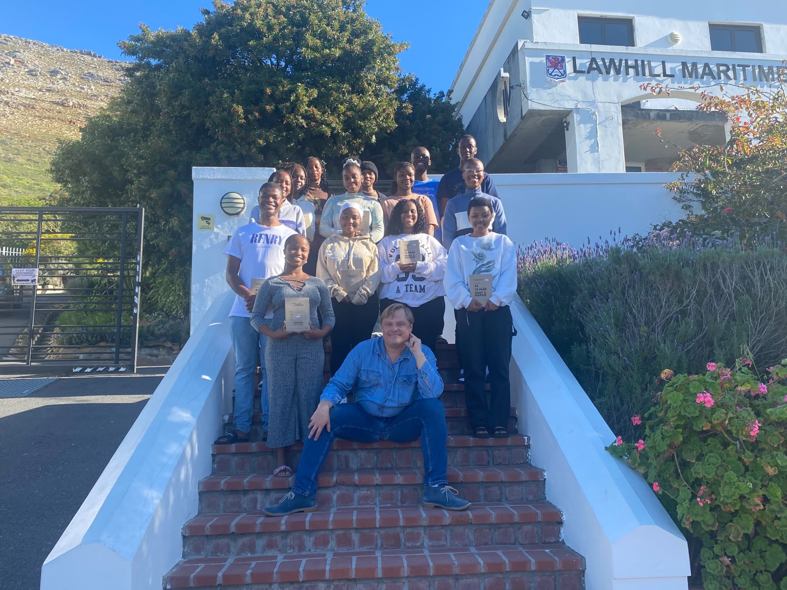Paul Tosio with a group of students holding their Easy Cheetah manuals at the Lawhill Maritime Centre