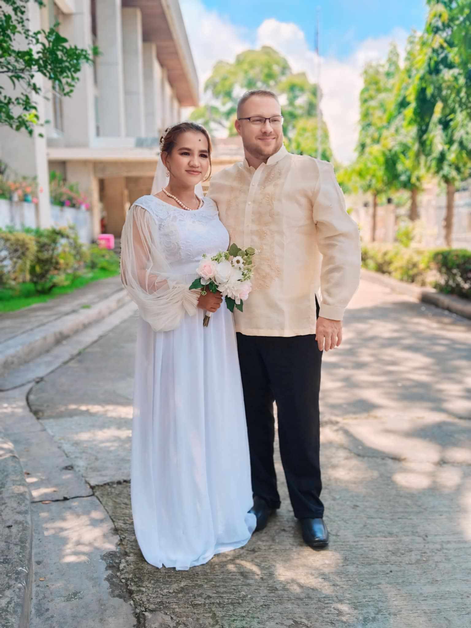 Jeremy and Maricel standing together on their wedding day.