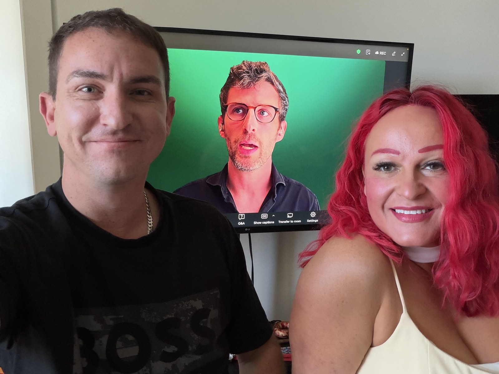 Helen and Zack Scriven grinning on the couch, with Stedi founder Zack Kanter mid-sentence on the living room TV behind them — the first Stedi Keynote, September 9, 2026