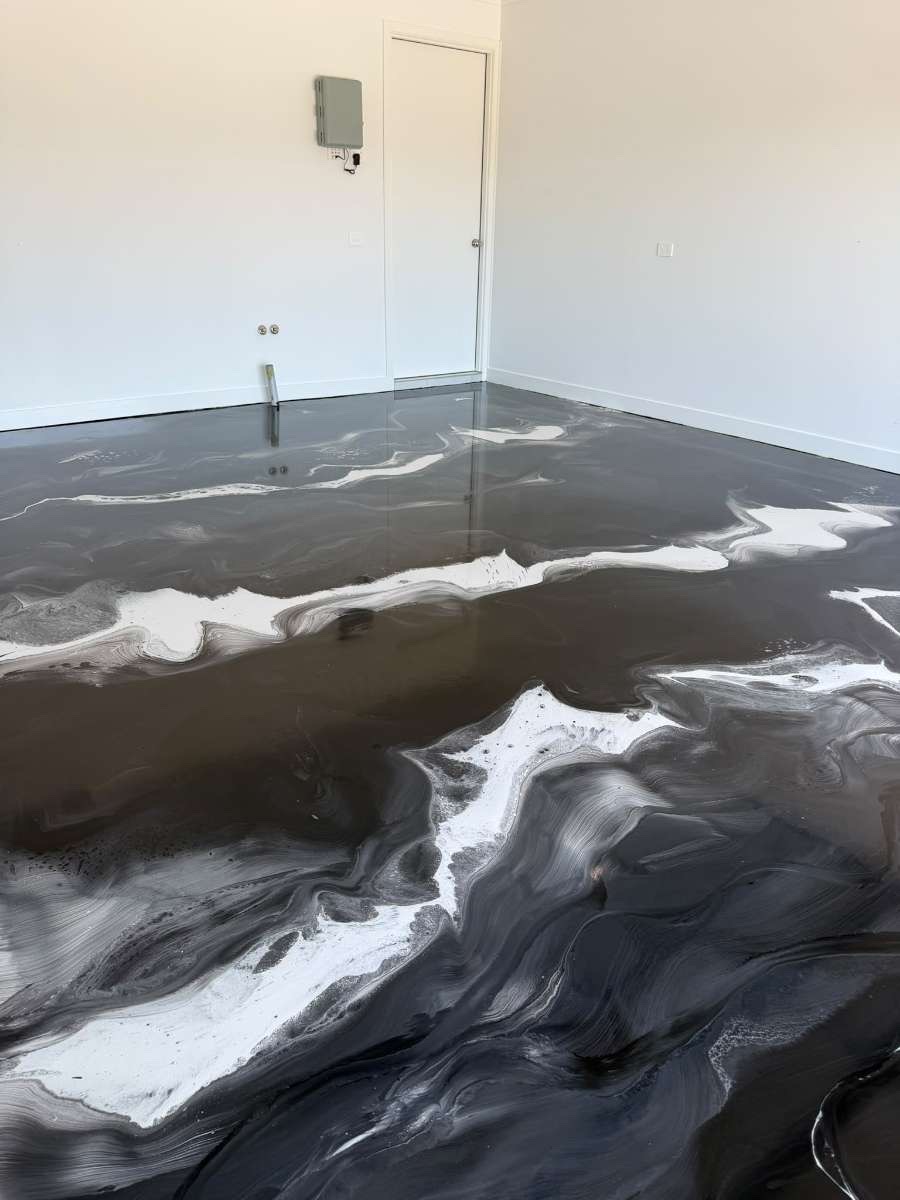 Smooth, reflective metallic epoxy surface showing the depth of the hand-worked finish