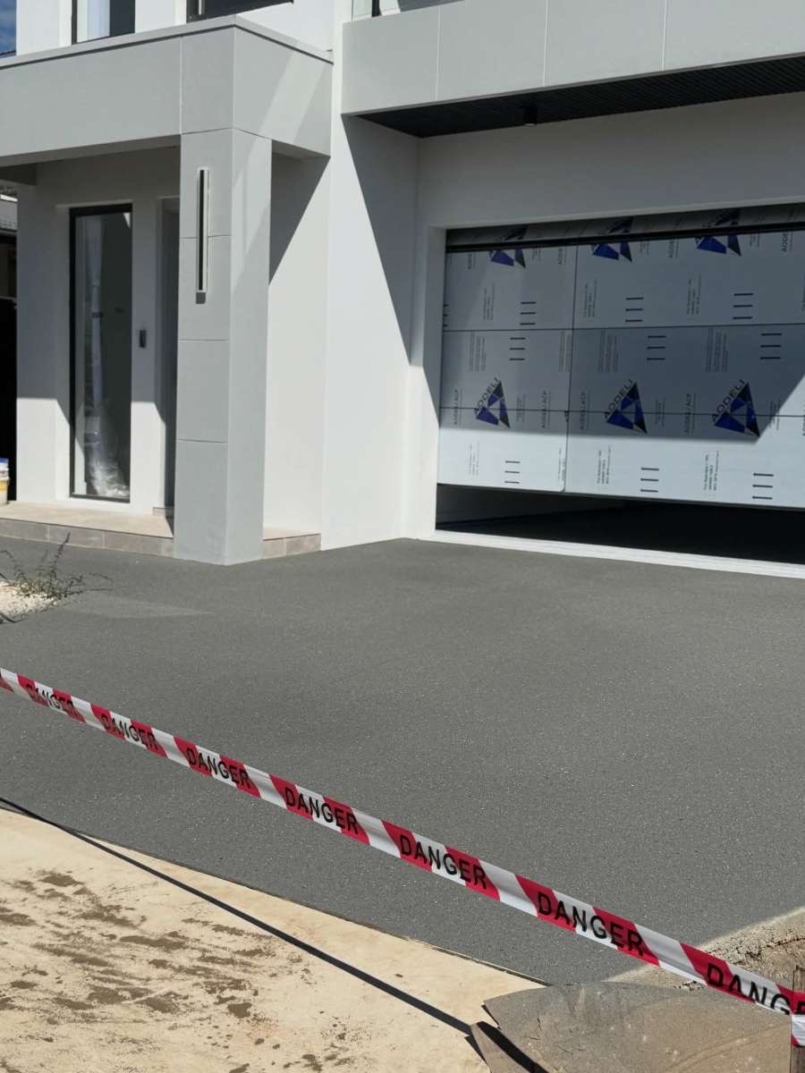 Close-up of the decorative, non-slip Spray Crete finish along the driveway edge