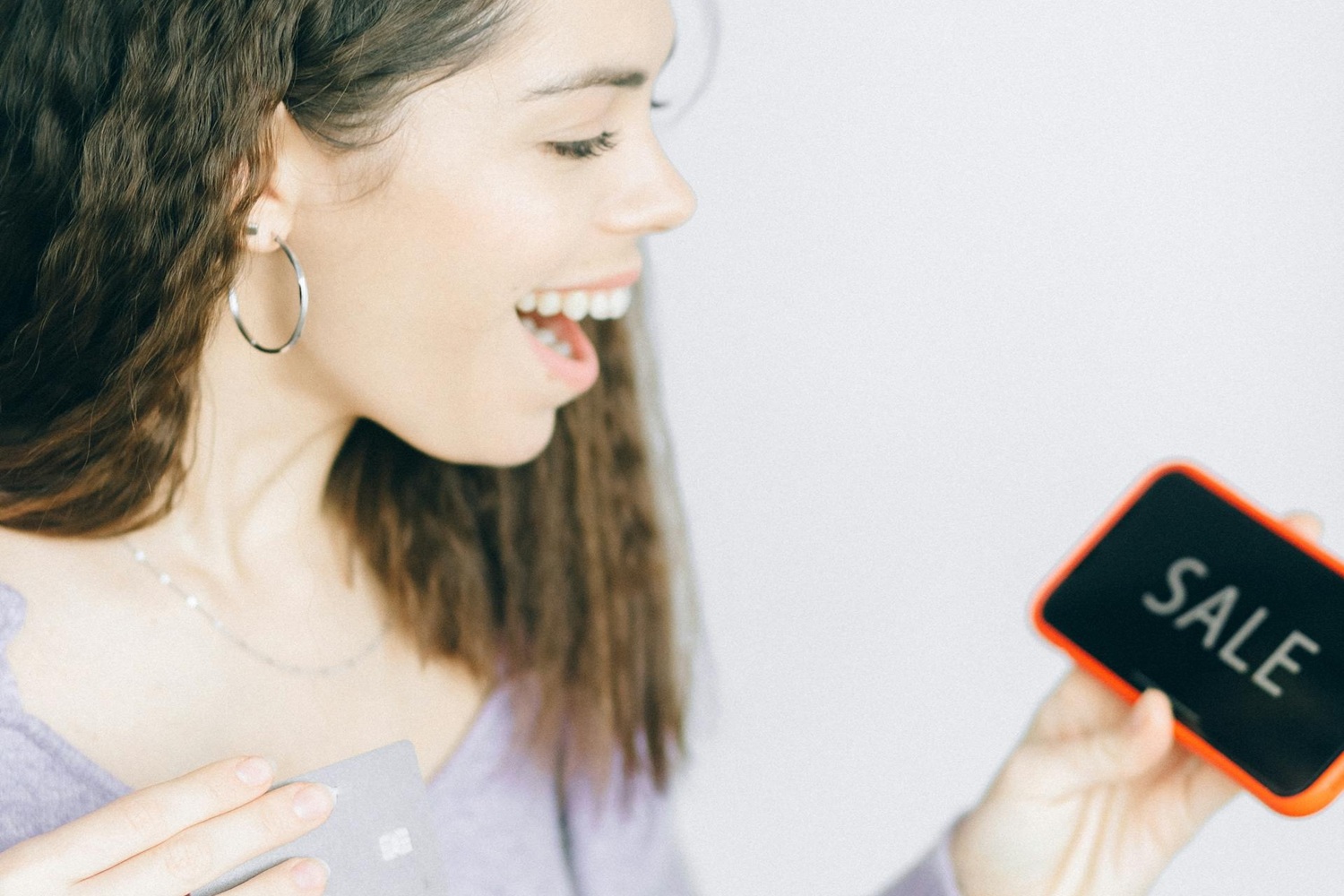 girl with phone thats reads SALE girl with phone thats reads SALE