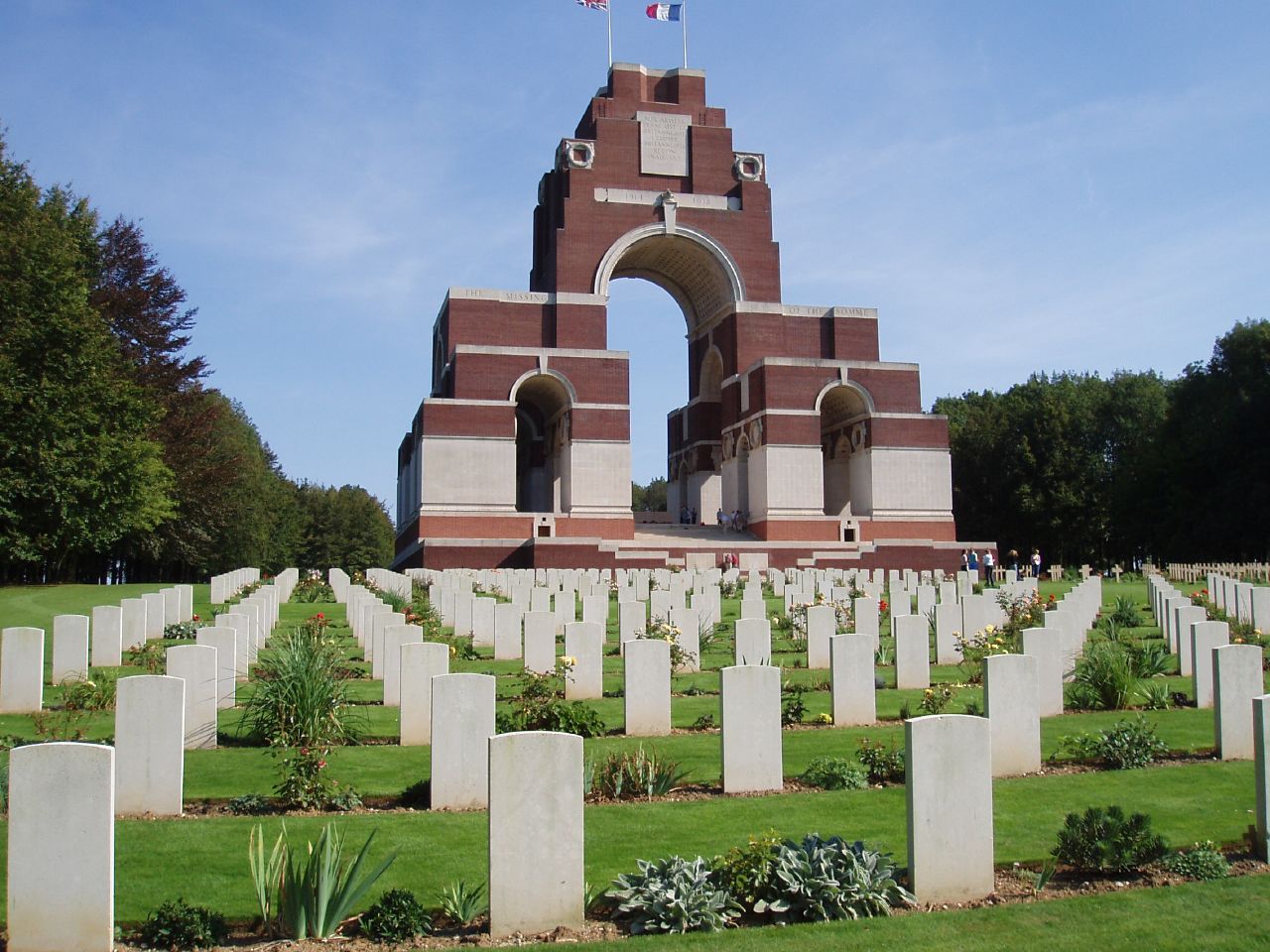 Thiepval Anglo-French Cemetery behind the Thiepval Memorial to the Missing of the Somme, a major World War I memorial in northern France.