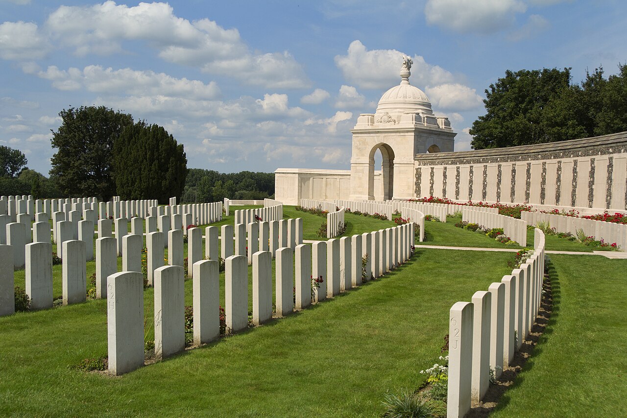 Tyne Cot Commonwealth War Graves Cemetery near Ypres, Belgium, with rows of white headstones and the memorial wall from the World War I Battle of Passchendaele.