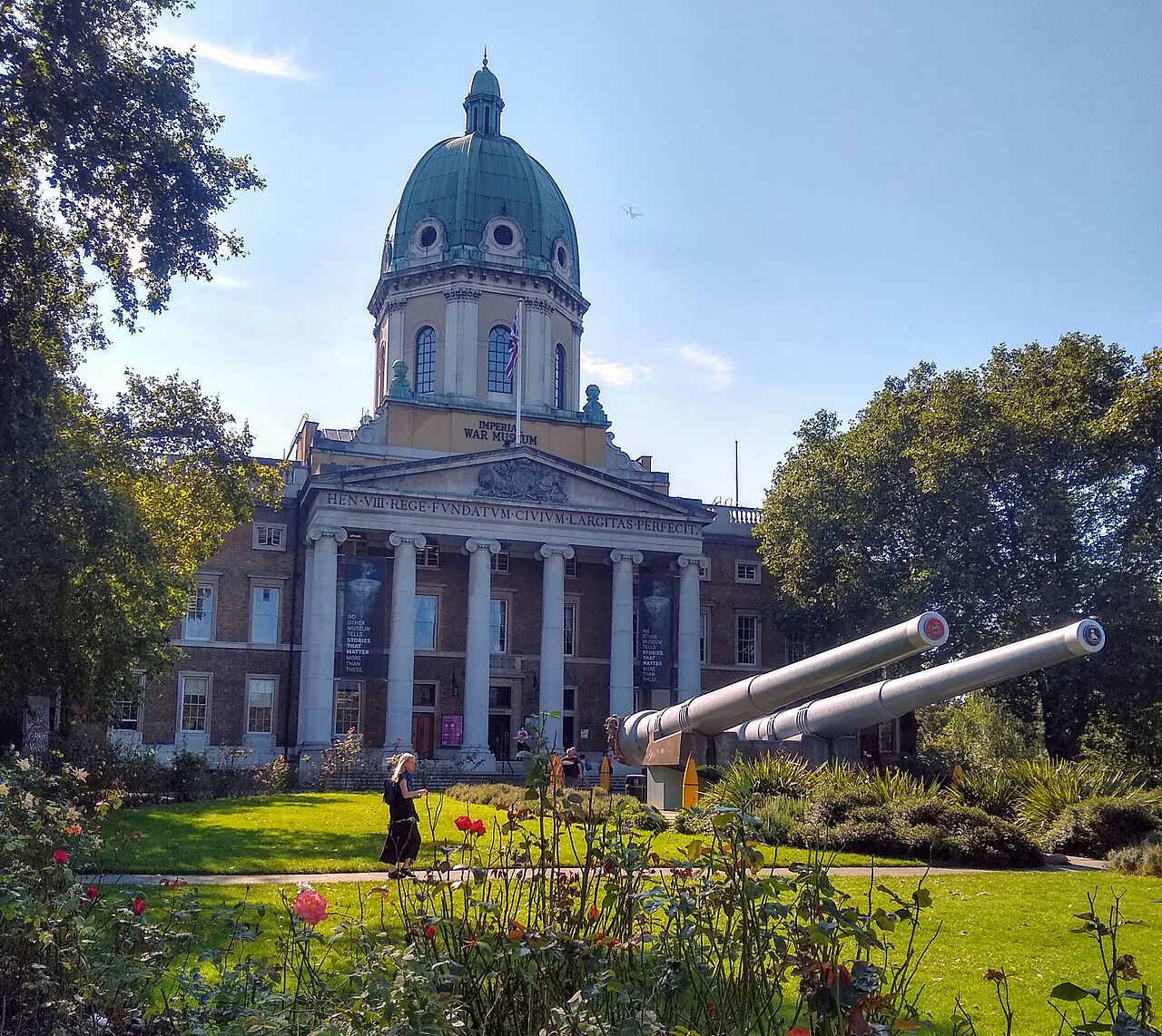 Imperial War Museum London building in Southwark with historic naval guns displayed outside the entrance.