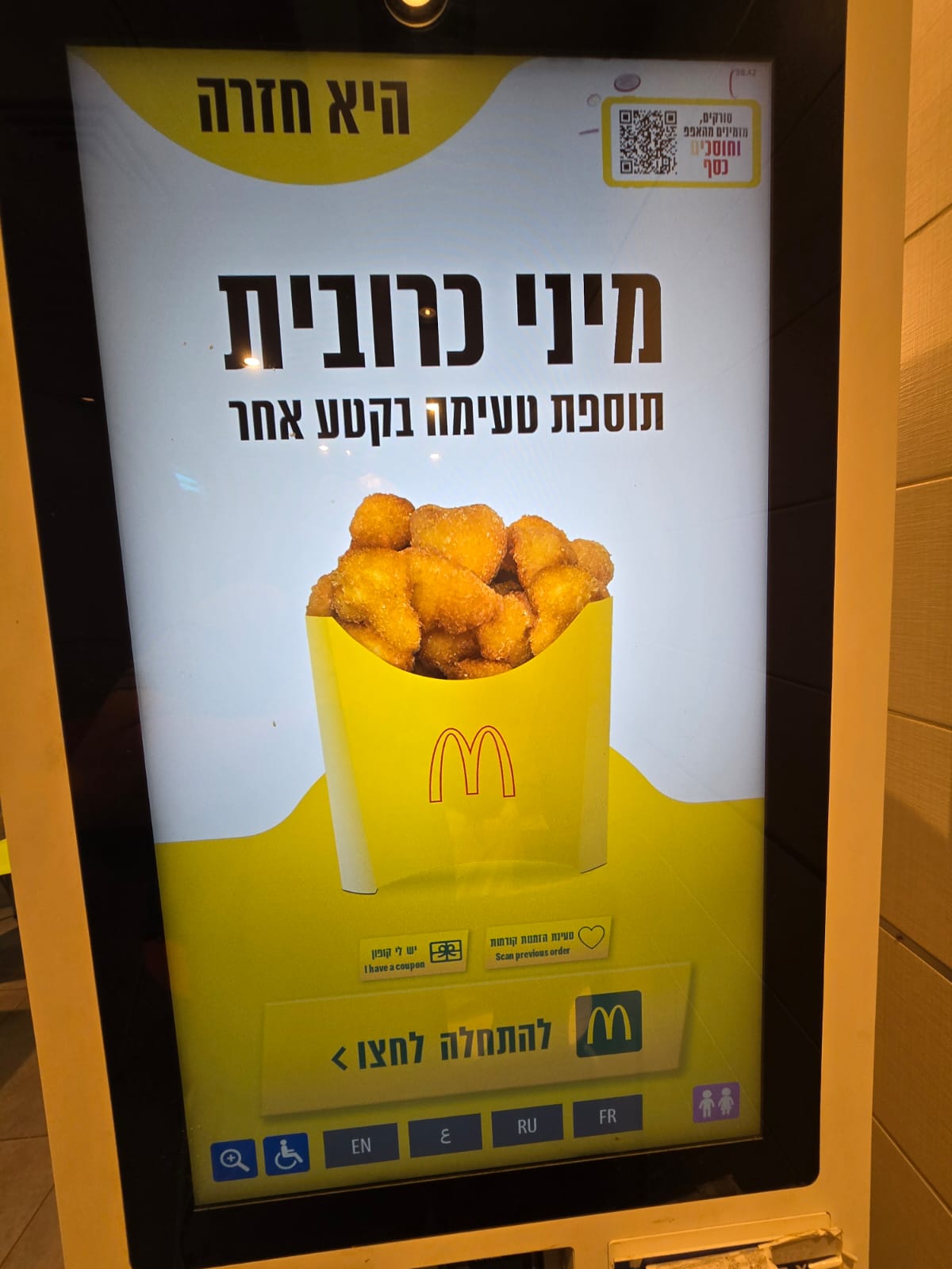 Self-service ordering kiosk at a McDonald's restaurant in Israel displaying a promotion for mini corn schnitzel nuggets in Hebrew. Self-service ordering kiosk at a McDonald's restaurant in Israel displaying a promotion for mini corn schnitzel nuggets in Hebrew.