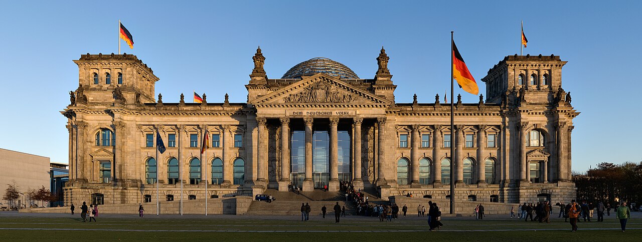 Reichstag building in Berlin, Germany, seat of the German Bundestag parliament with historic façade and glass dome.