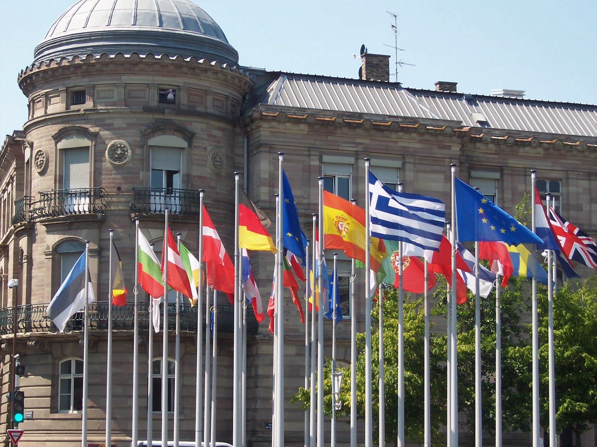 European national flags and EU member state flags flying outside Strasbourg station in France, symbolizing European unity and international cooperation. European national flags and EU member state flags flying outside Strasbourg station in France, symbolizing European unity and international cooperation.