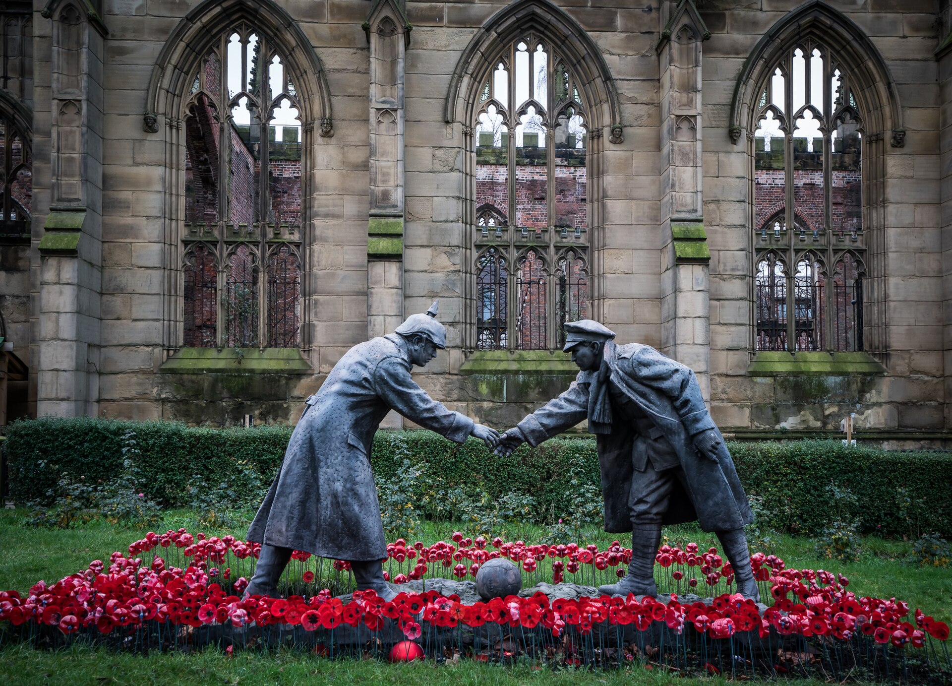Christmas Truce statue "All Together Now" in Liverpool showing British and German soldiers meeting over a football in remembrance of the 1914 World War I truce.