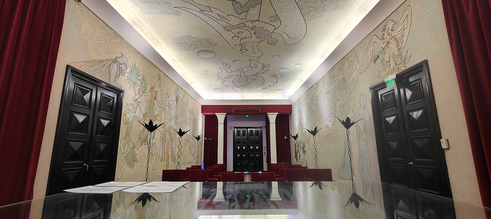 Interior of the wedding hall decorated by Jean Cocteau in Menton, France, featuring surrealist-inspired murals and artistic designs connected to twentieth-century French modernism. Interior of the wedding hall decorated by Jean Cocteau in Menton, France, featuring surrealist-inspired murals and artistic designs connected to twentieth-century French modernism.