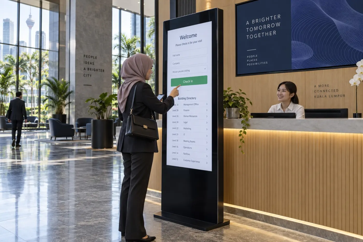 Visitor checking in at a touchscreen kiosk in an office lobby
