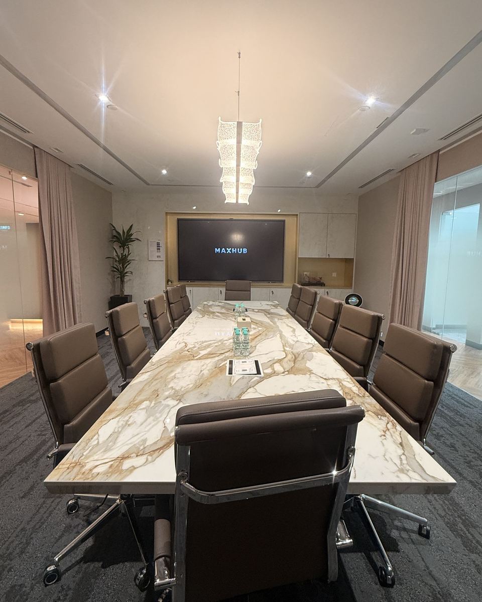 Marble-table boardroom with a wall-mounted panel