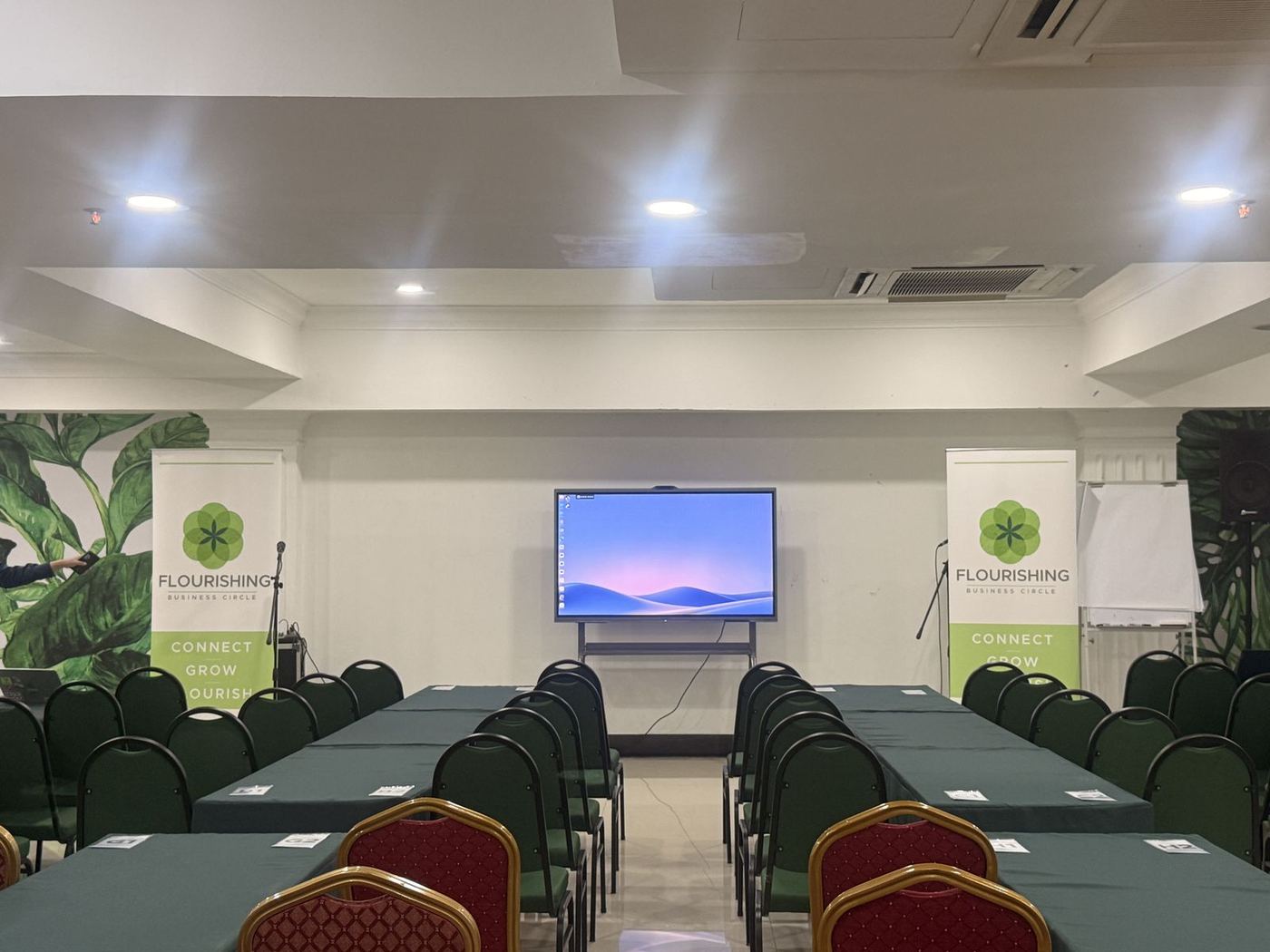 Seminar room set up for an event with an interactive display