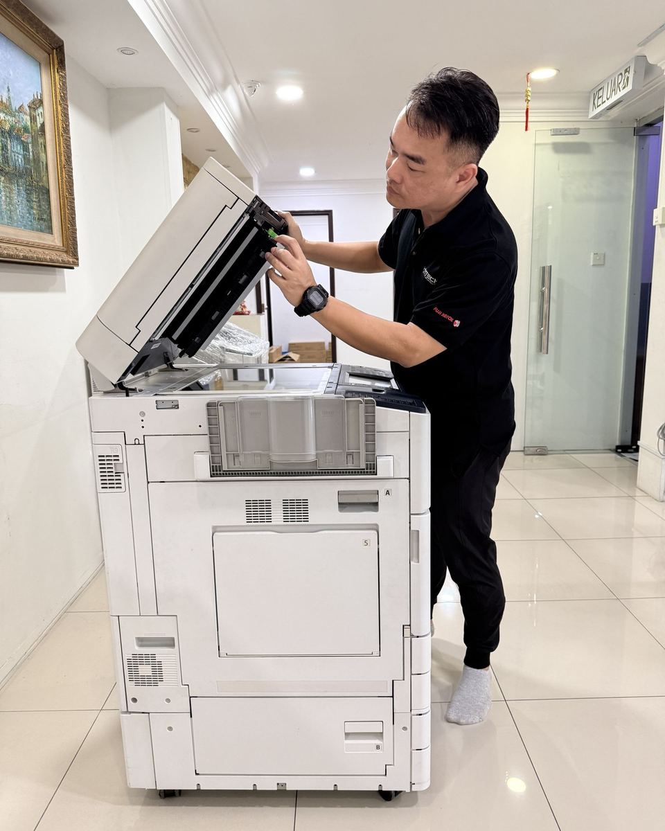 Hytech technician servicing a photocopier