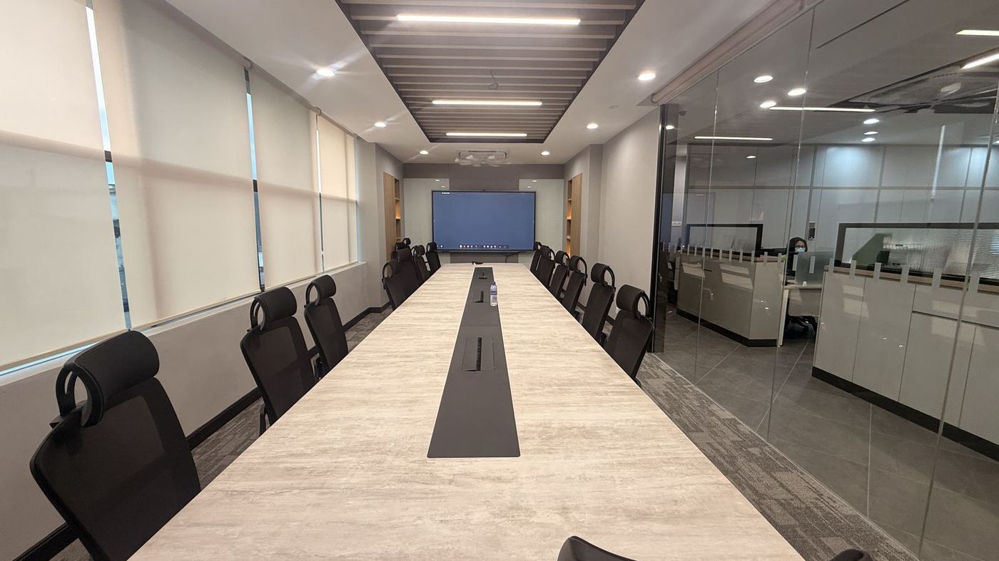 Glass-partition meeting room with an interactive panel