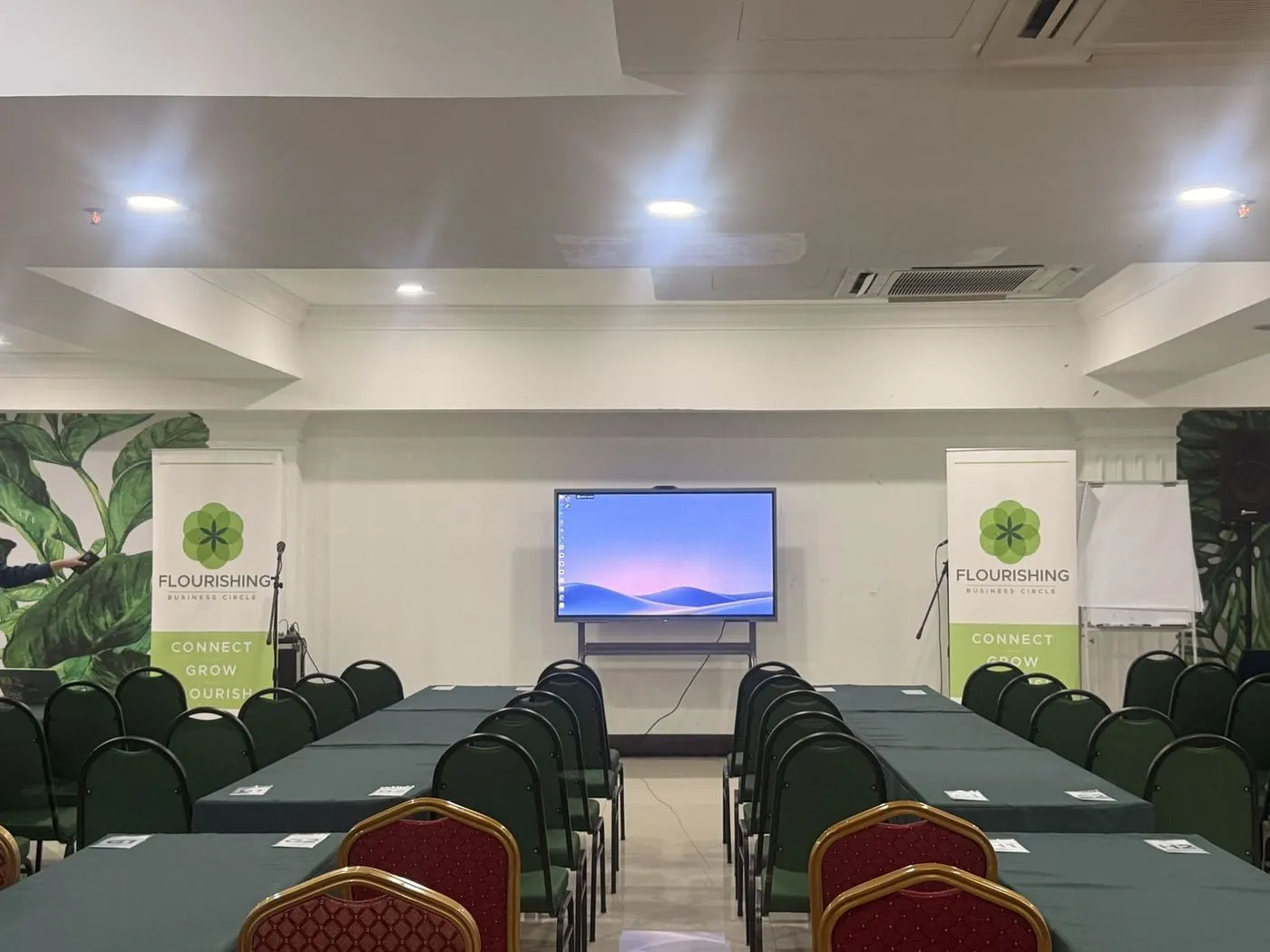 Seminar room set up for an event with an interactive display