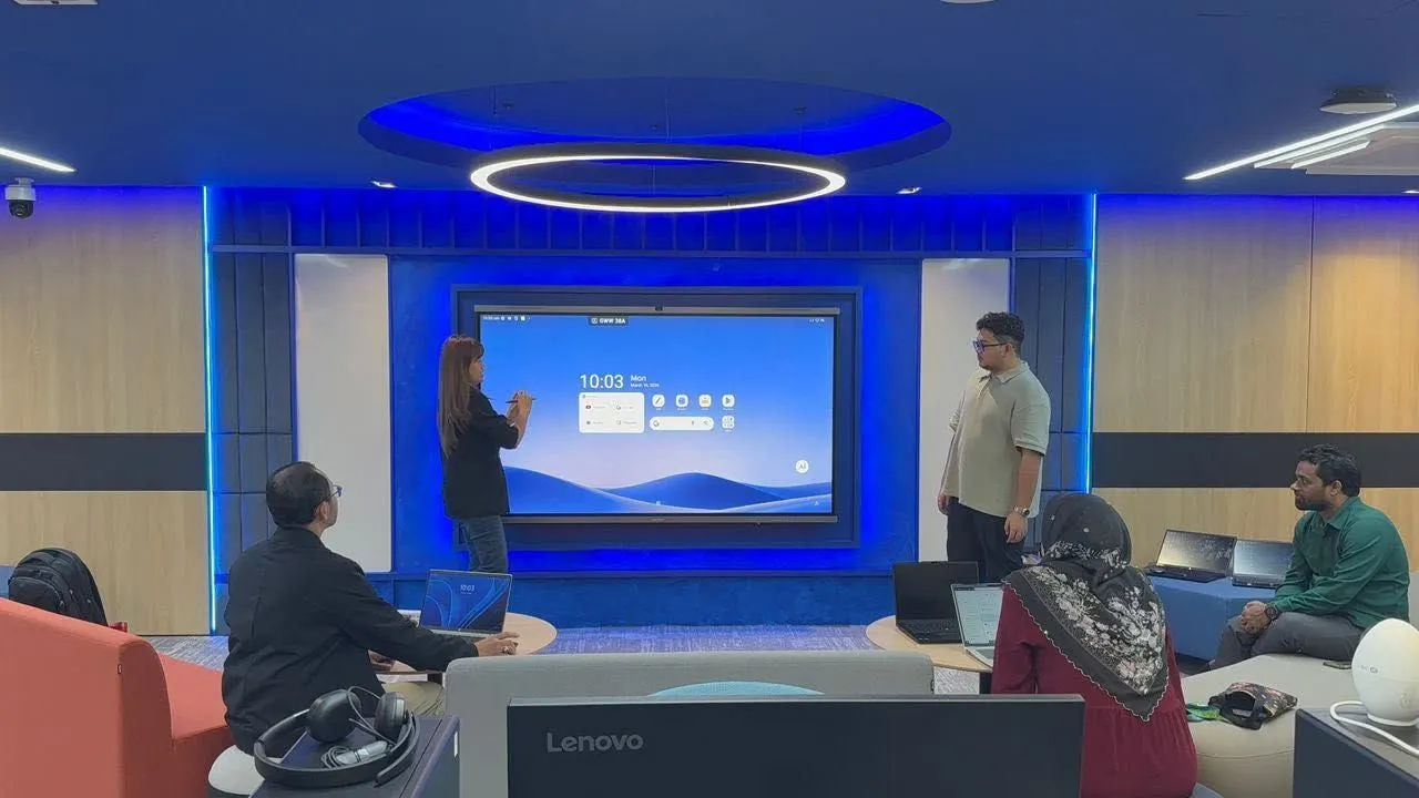 Team using a MAXHUB interactive panel in a collaboration room fitted by Hytech