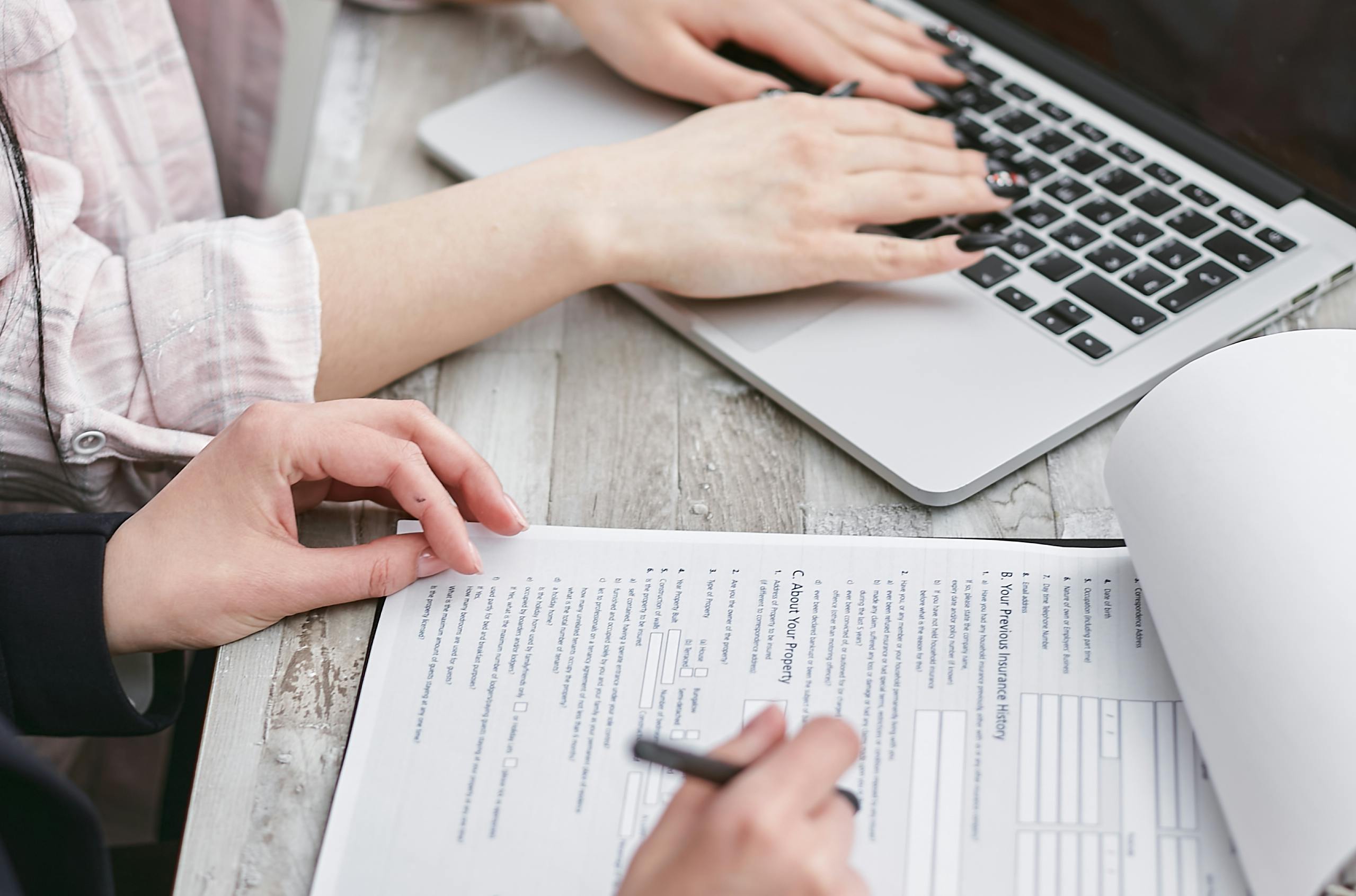 Filling in a form next to a laptop