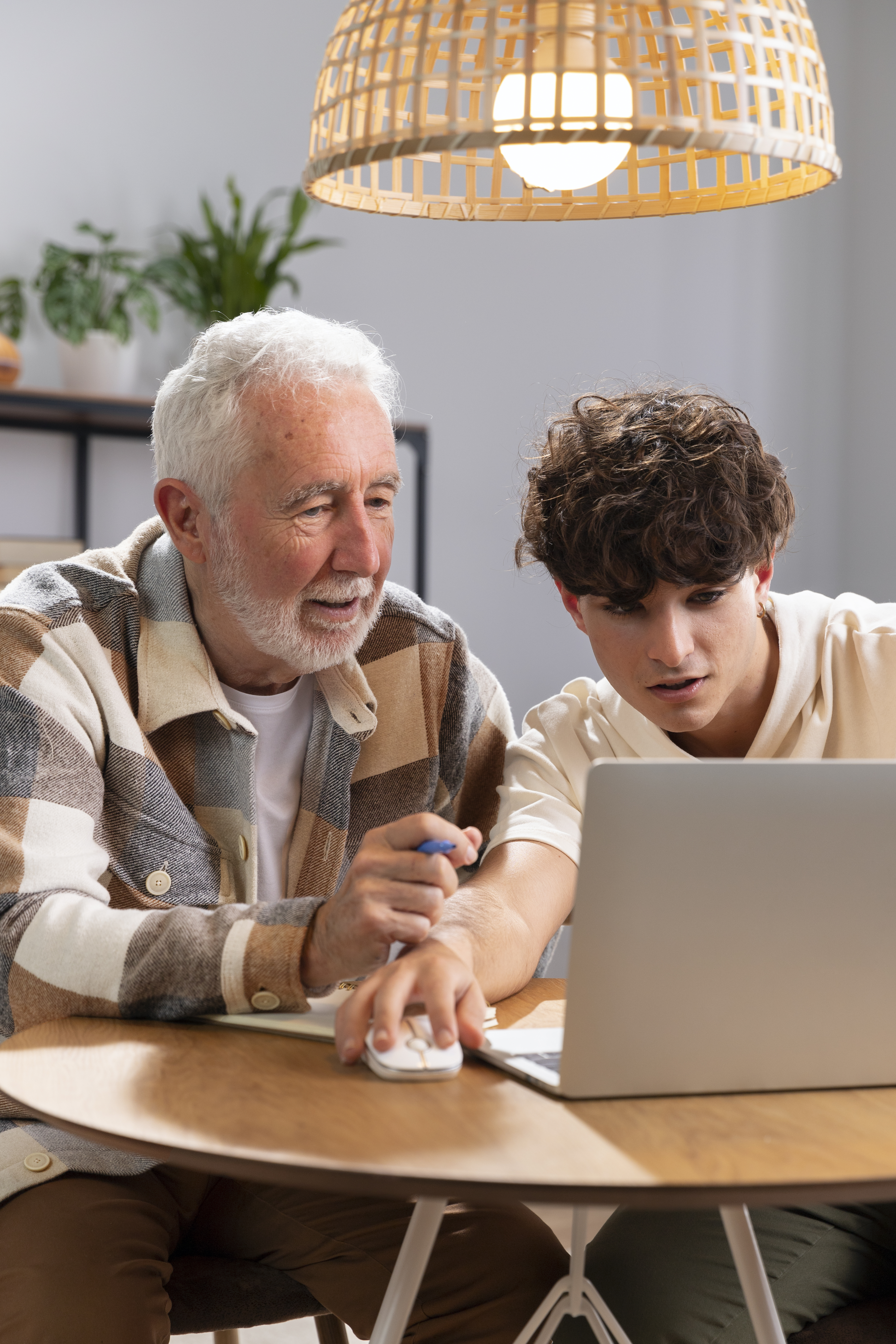 A grandfather and grandson using a laptop