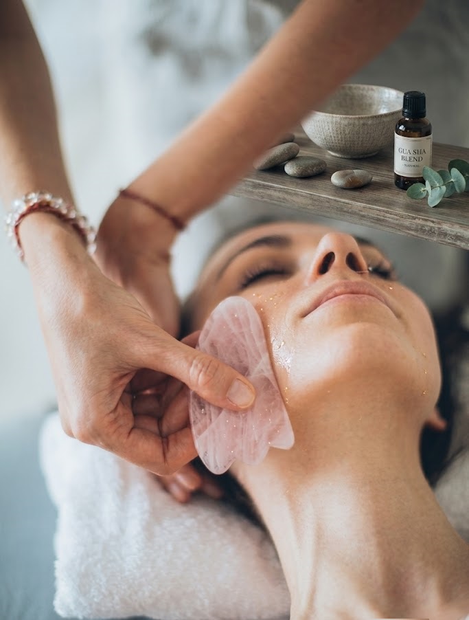 A gua sha tool being used during a treatment