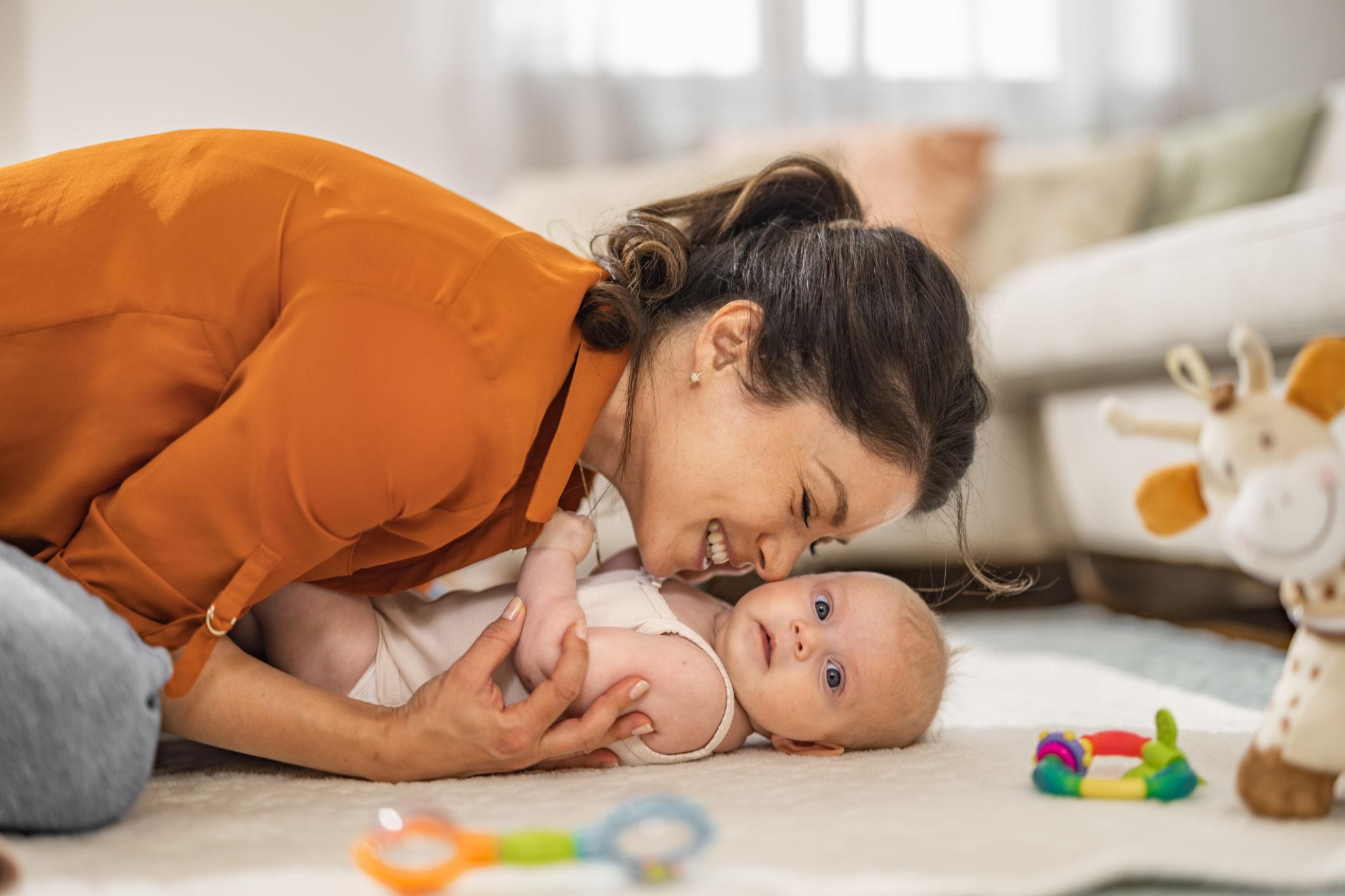 Caregiver engaging with a baby through play