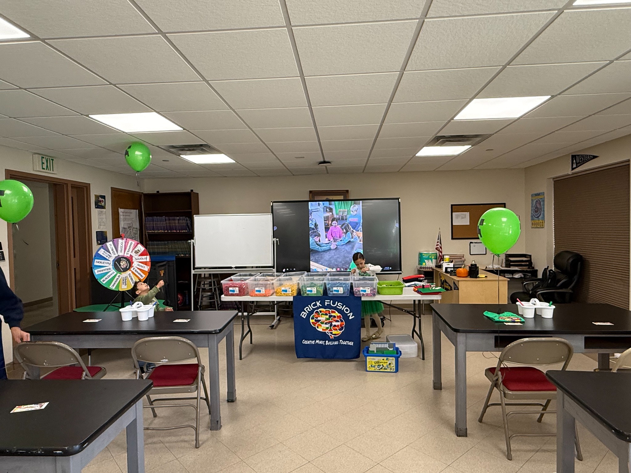 Brick Fusion birthday party room set up with building tables