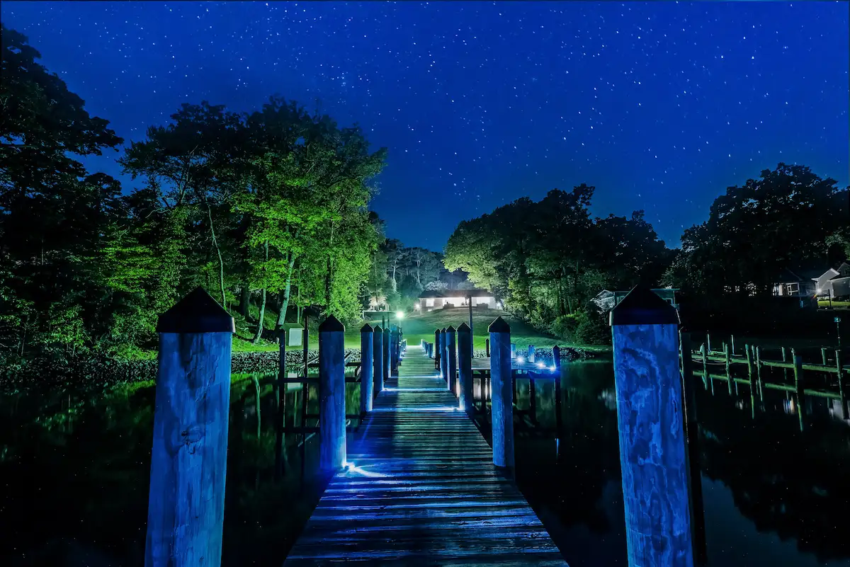 Lit private dock at night on the water in Southern Maryland