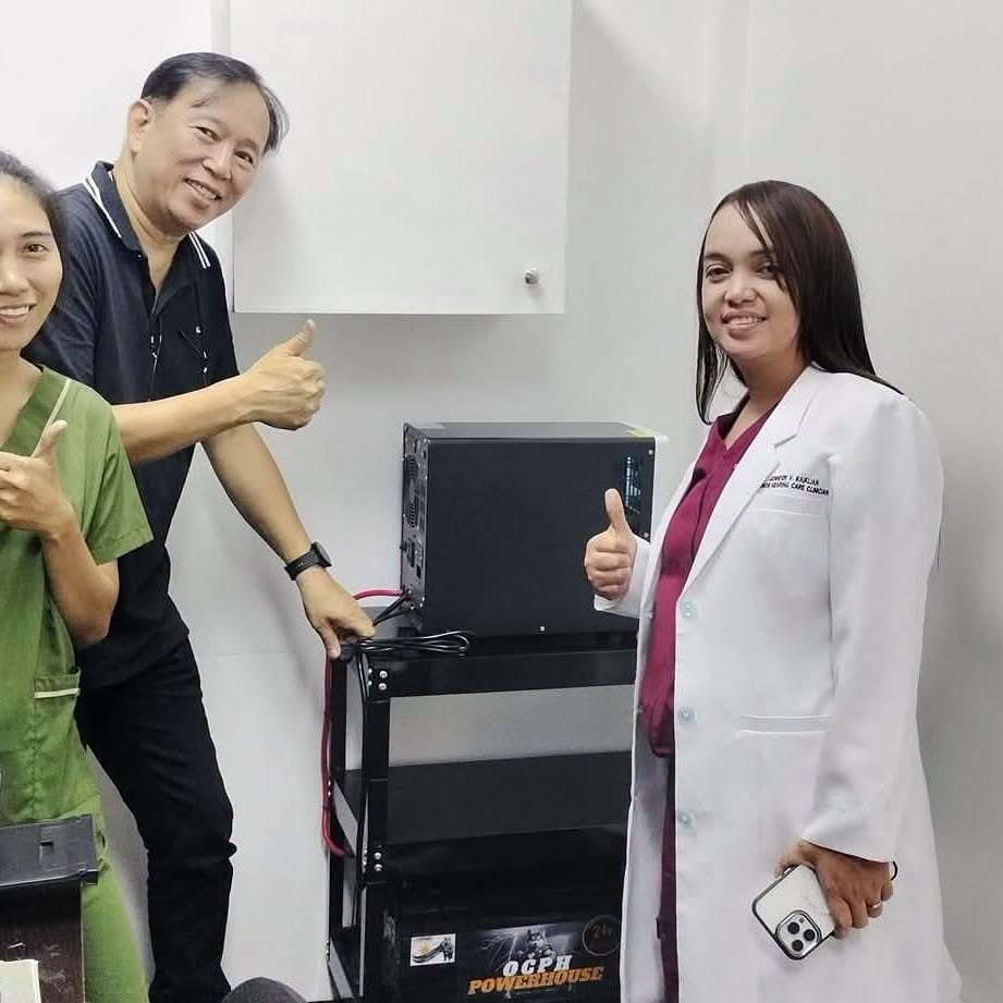 Staff at MedicEAR Hearing Aid Center standing beside their installed OCPH unit on a rolling cart
