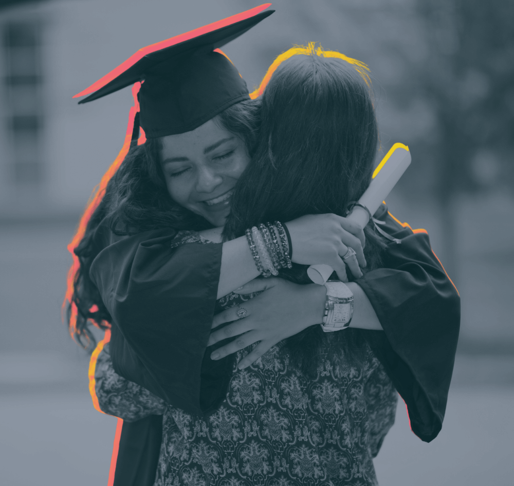 Female student hugging her mother on graduation day
