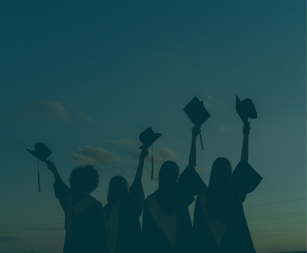 Graduates celebrating successful law and med school admissions at sunset