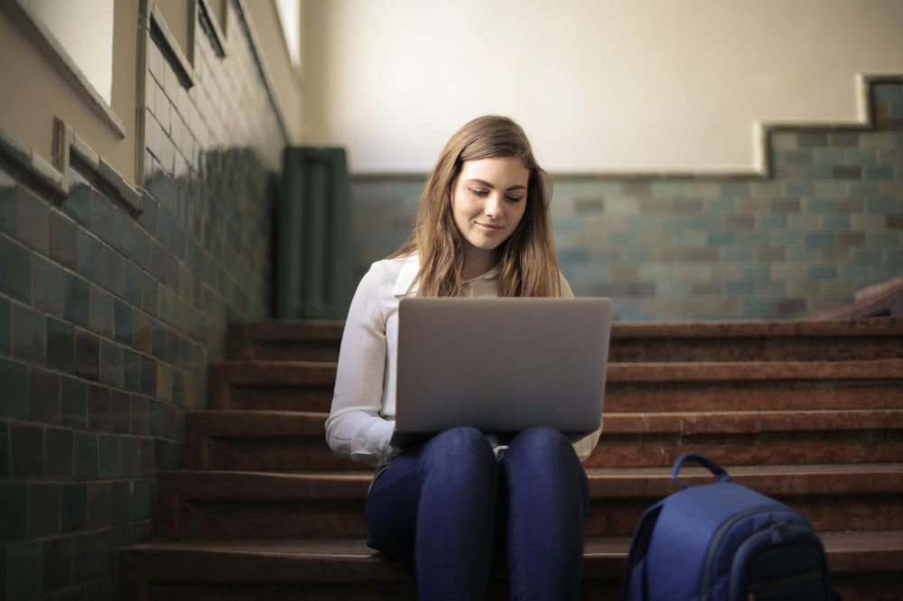 College student writing on laptop, preparing for law school admissions