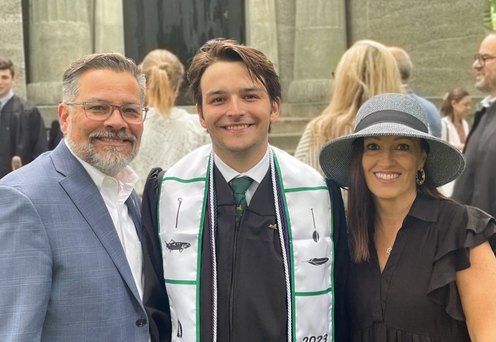 Admissions coaching student with parents during graduation