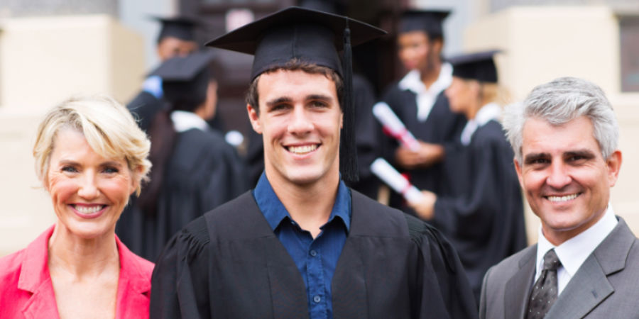 Male student with parents during graduation
