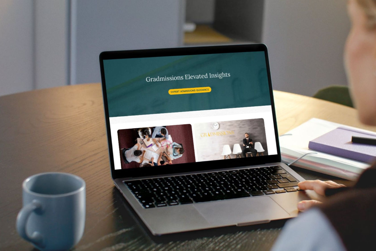 Someone reading the GradMissions Blog: Elevated Insights on their laptop