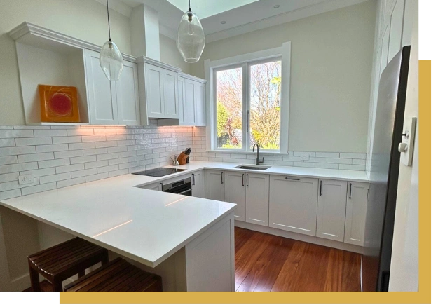 Modern kitchen remodel with stone benchtop and tiled splashback