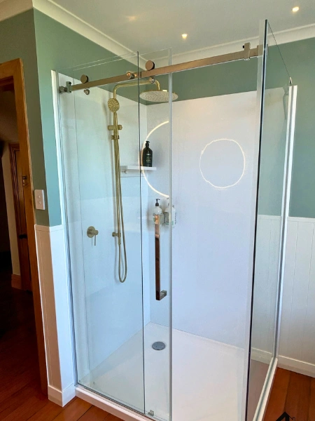 Bathroom upgrade with new floor tiles and frameless glass screen