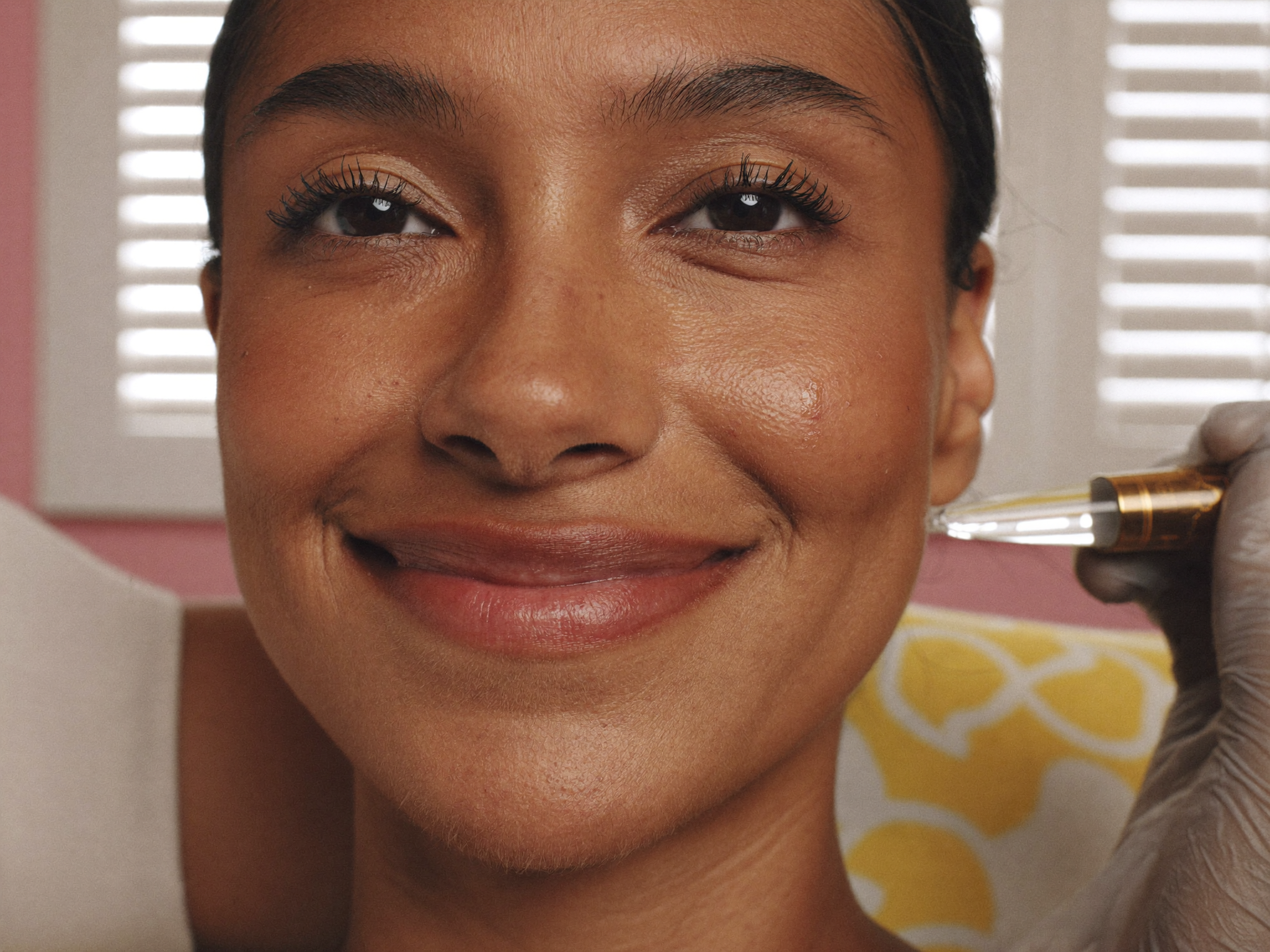 Esthetician using a high-frequency wand during an acne facial