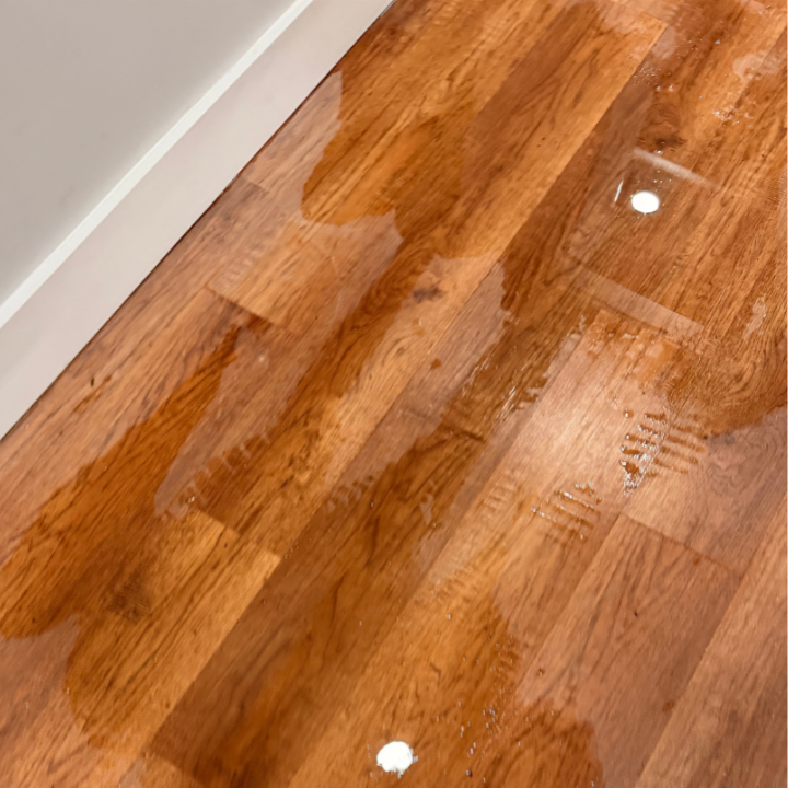 Standing water on a hardwood floor after a water leak in a Knoxville home Standing water on a hardwood floor after a water leak in a Knoxville home