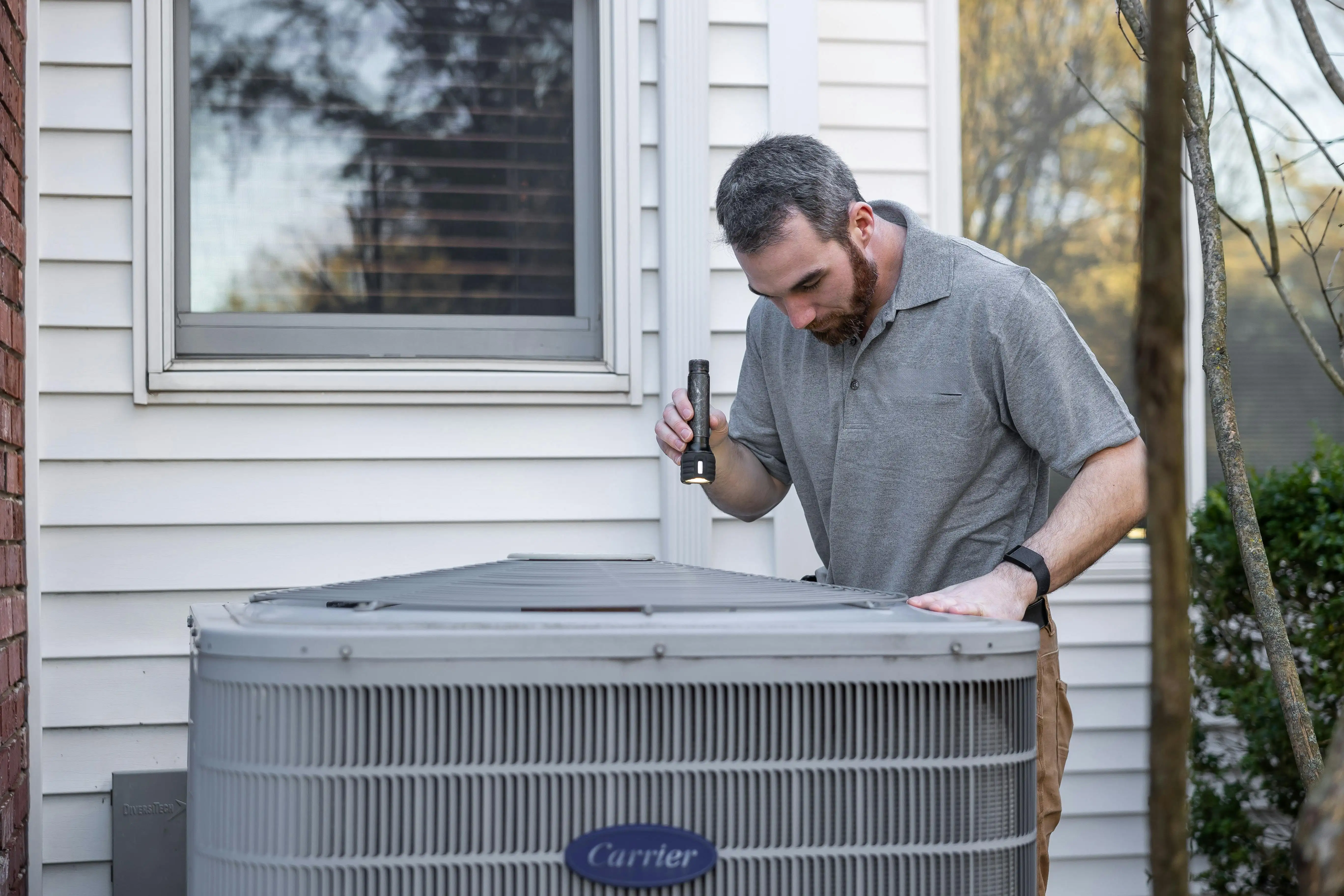 HVAC technician inspecting unit