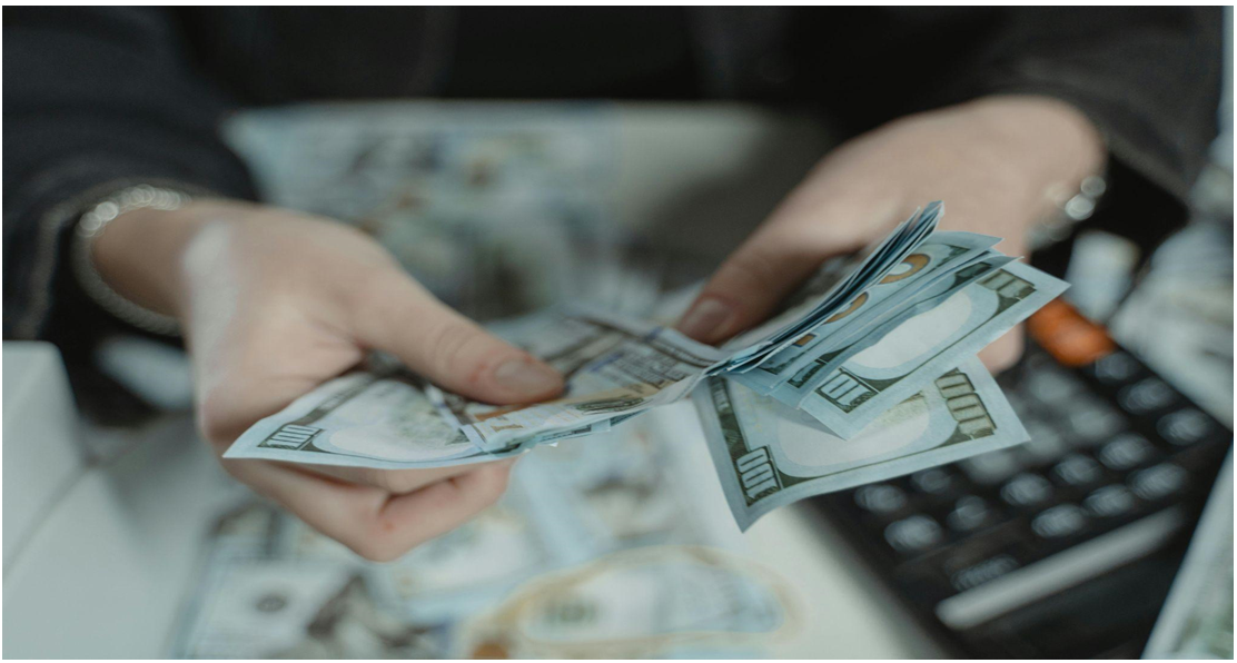 Counting cash beside a calculator