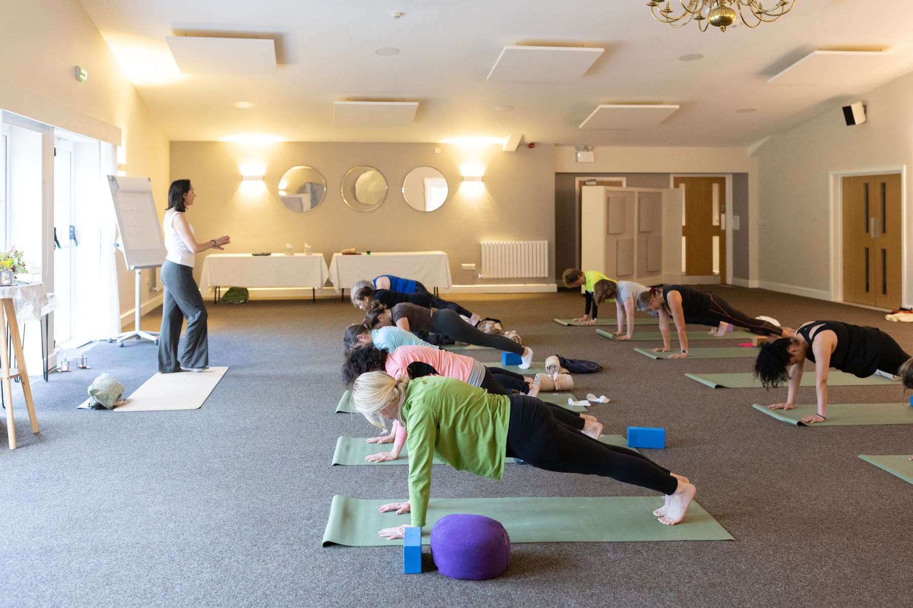 Group plank pose in the Yoga room