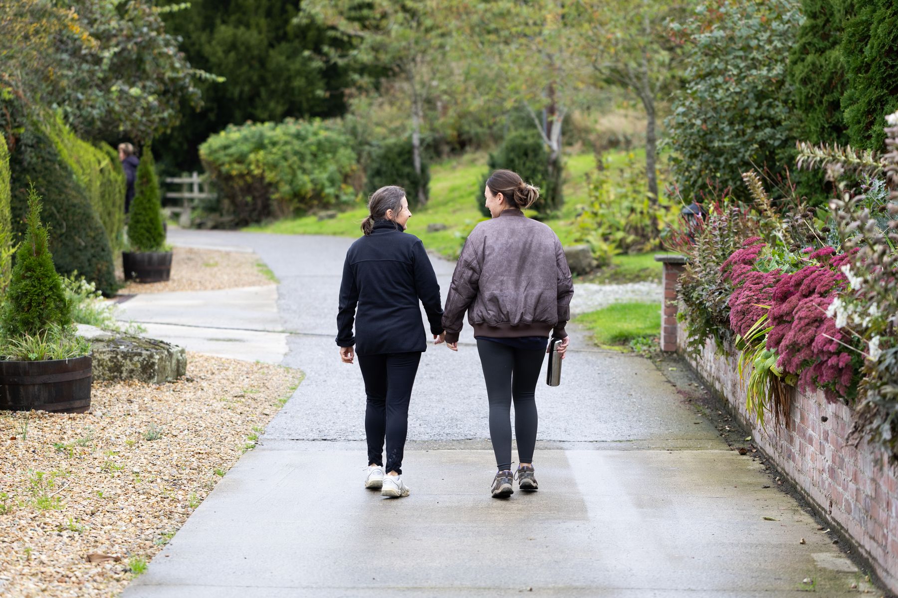 Two retreat guests walking hand in hand
