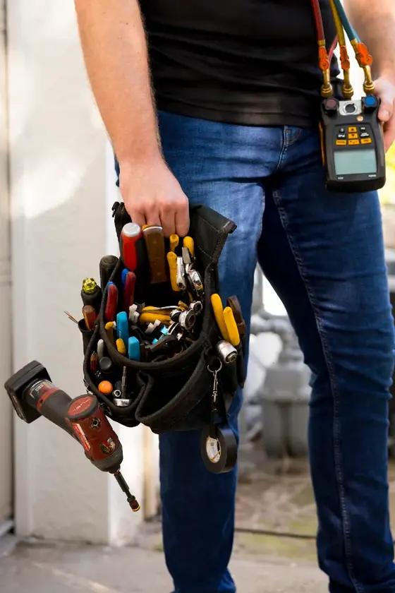 Air Mavericks technician carrying a tool bag and gauges