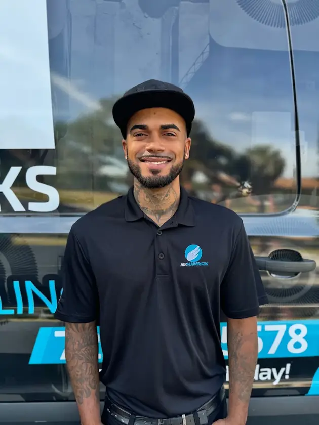 Air Mavericks technician in front of a company van
