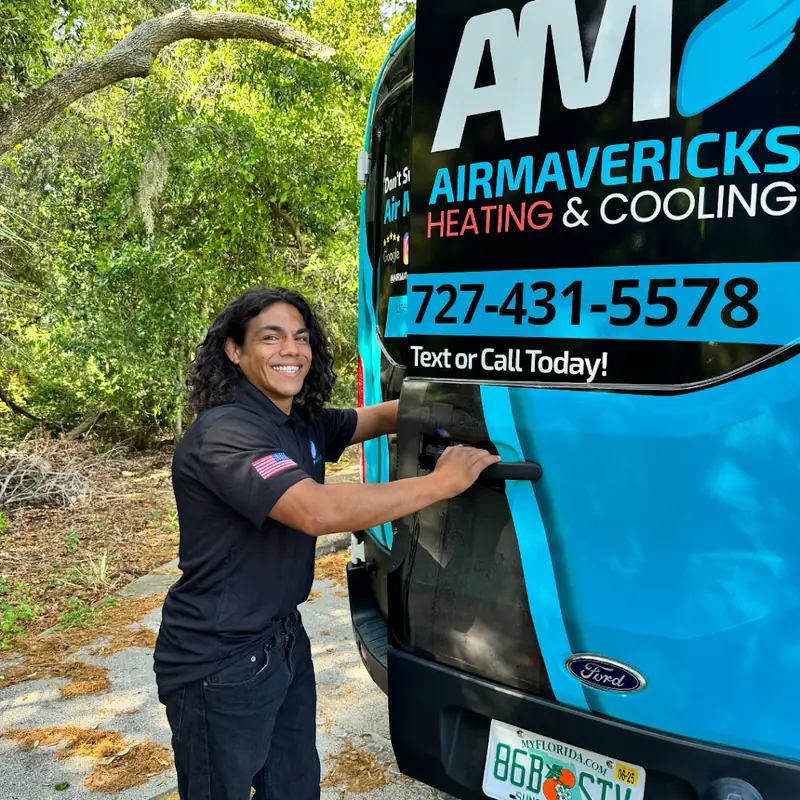 Air Mavericks technician at the back of a company van