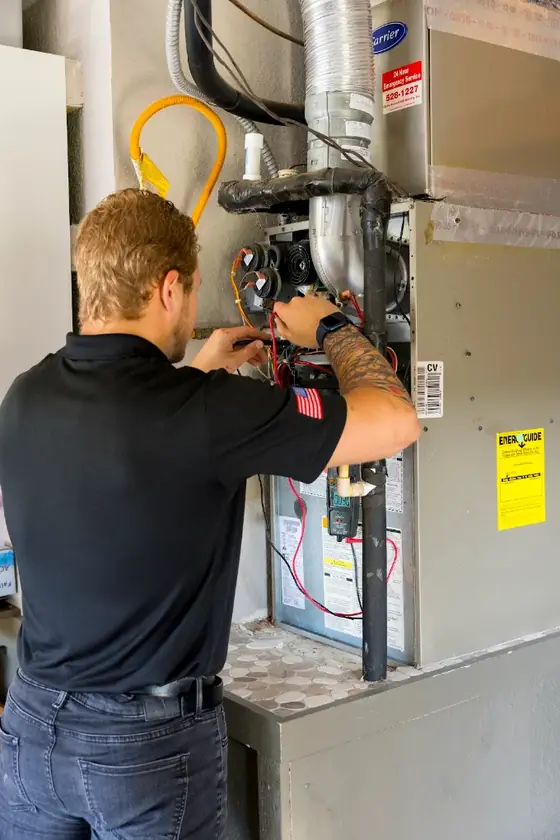 Technician working on a furnace and air handler