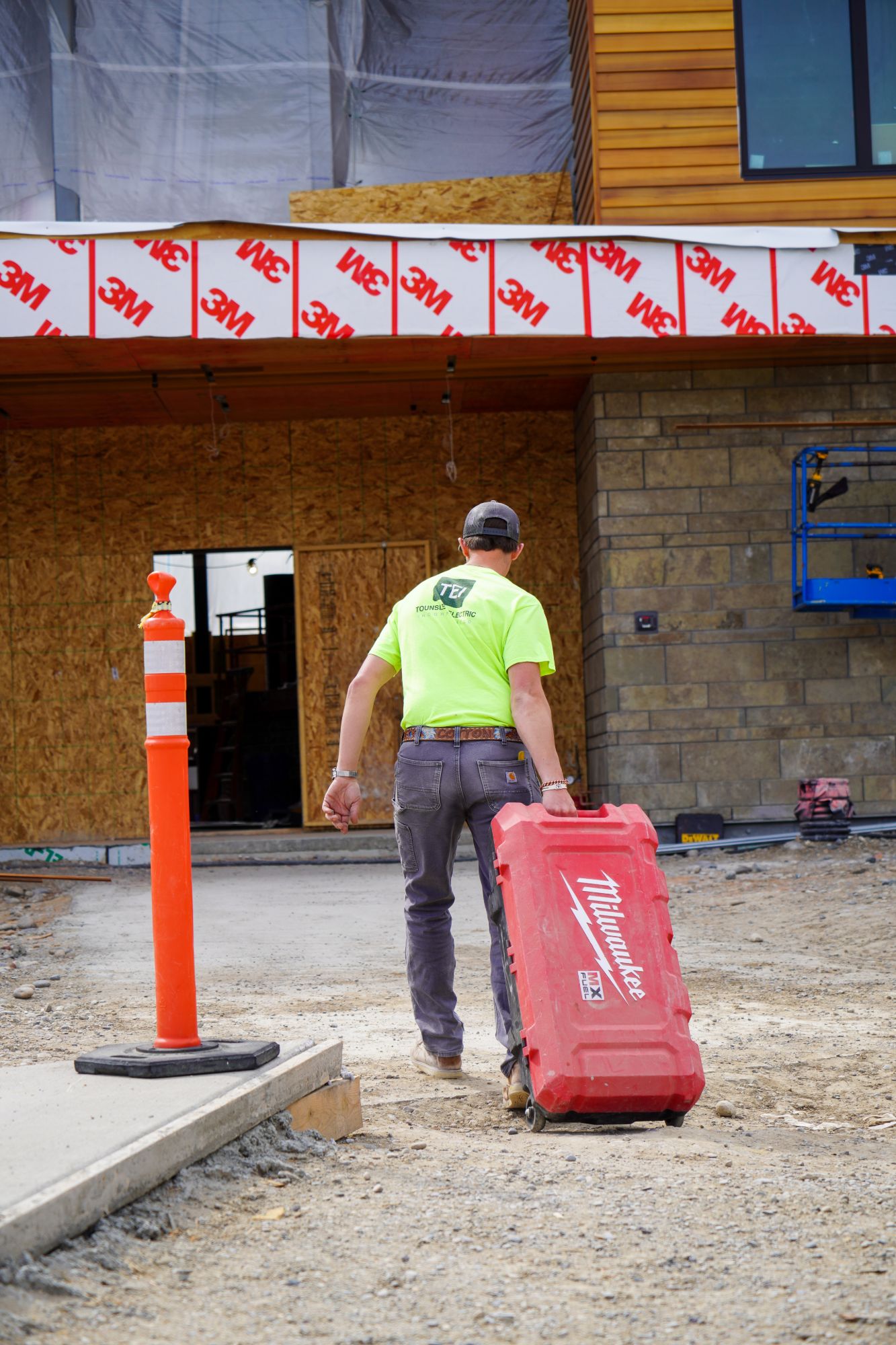 An electrician heading into a job site