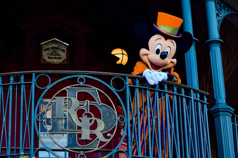 Mickey waving at park entrance