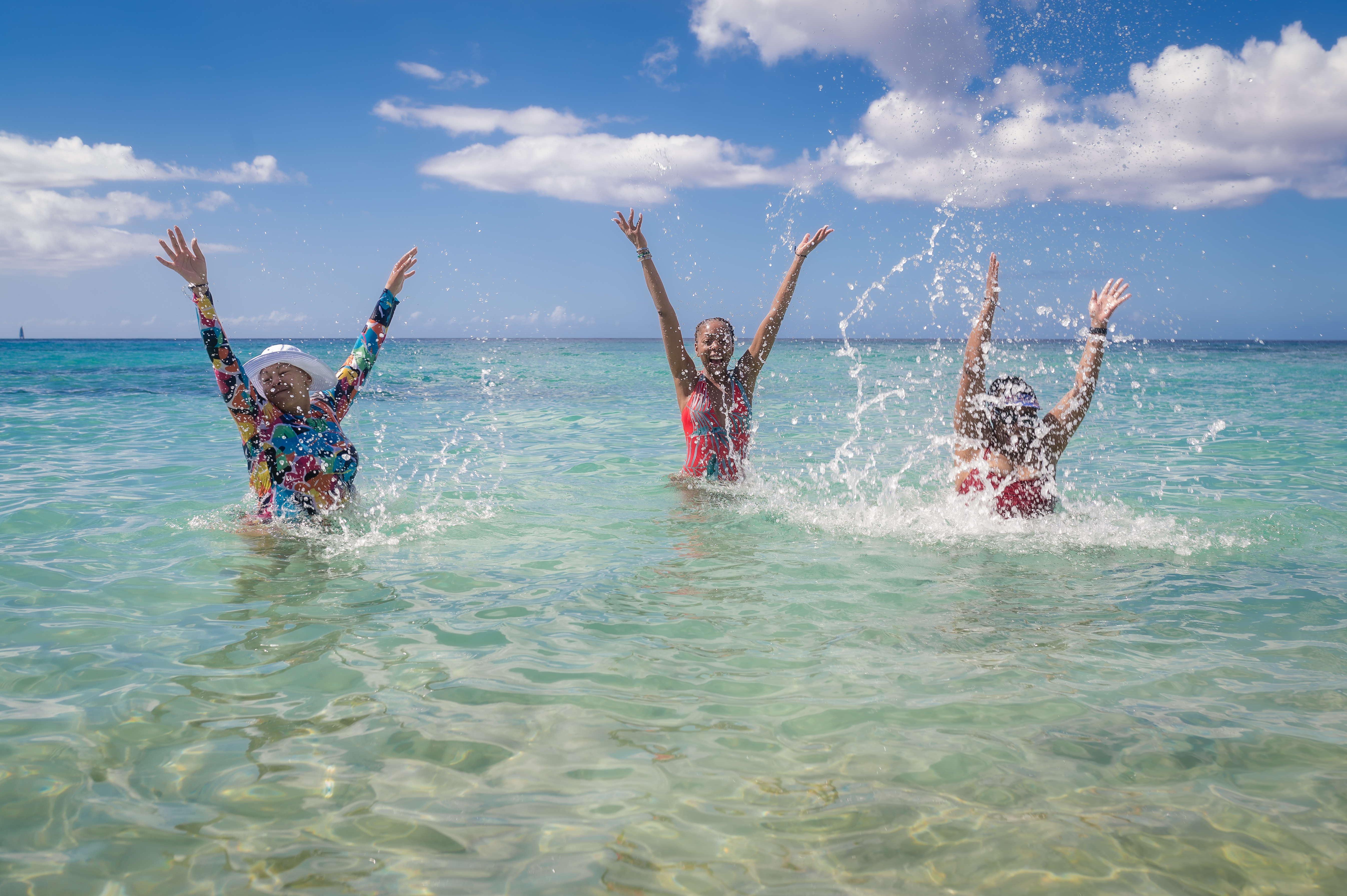 Women jumping in the ocean during the WANTED Woman Escape in Grenada Caribbean