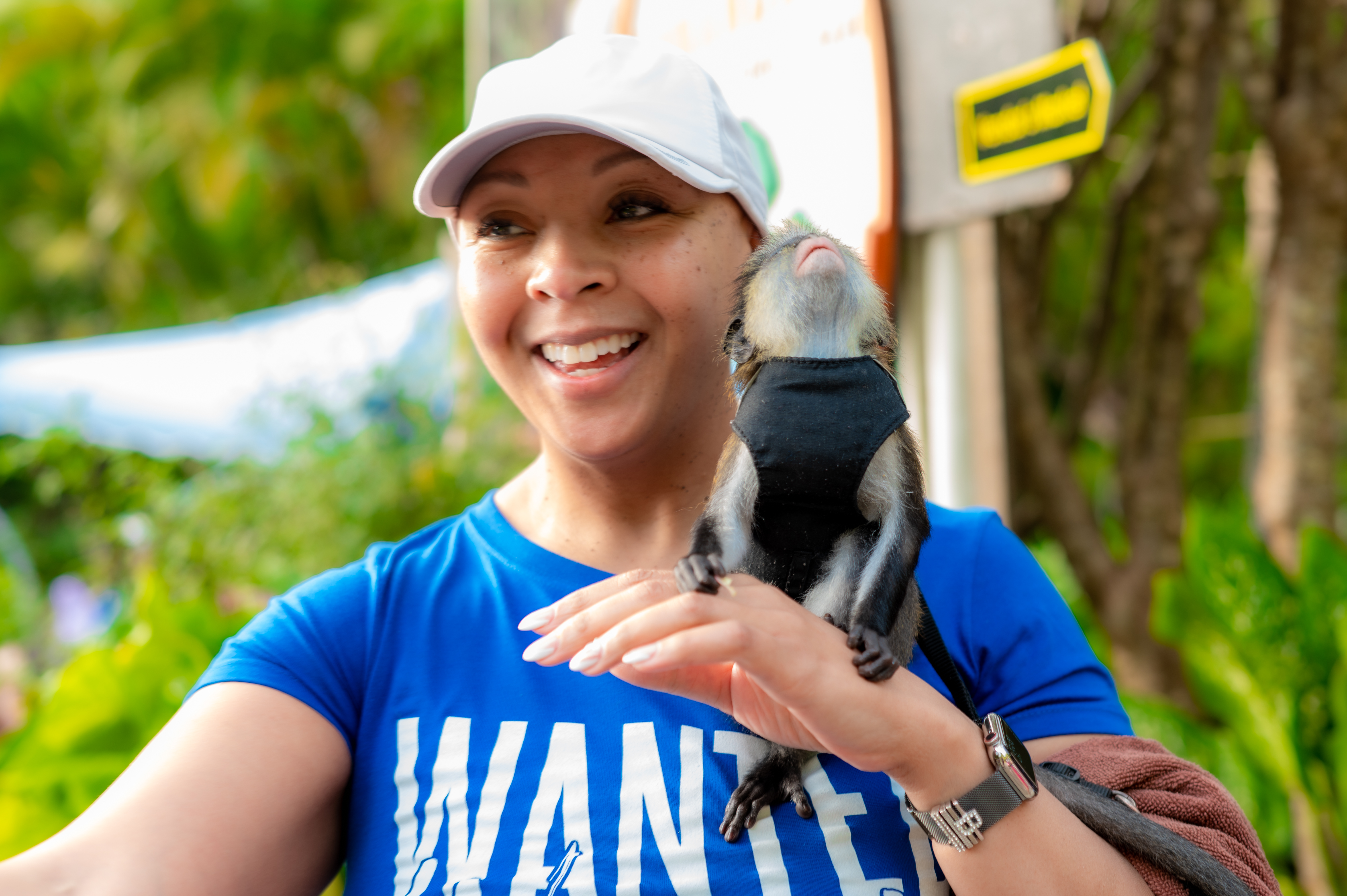 Woman holding a monkey during the WANTED Woman Escape in Grenada
